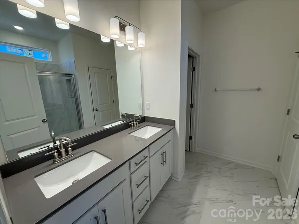 a bathroom with a glass shower door