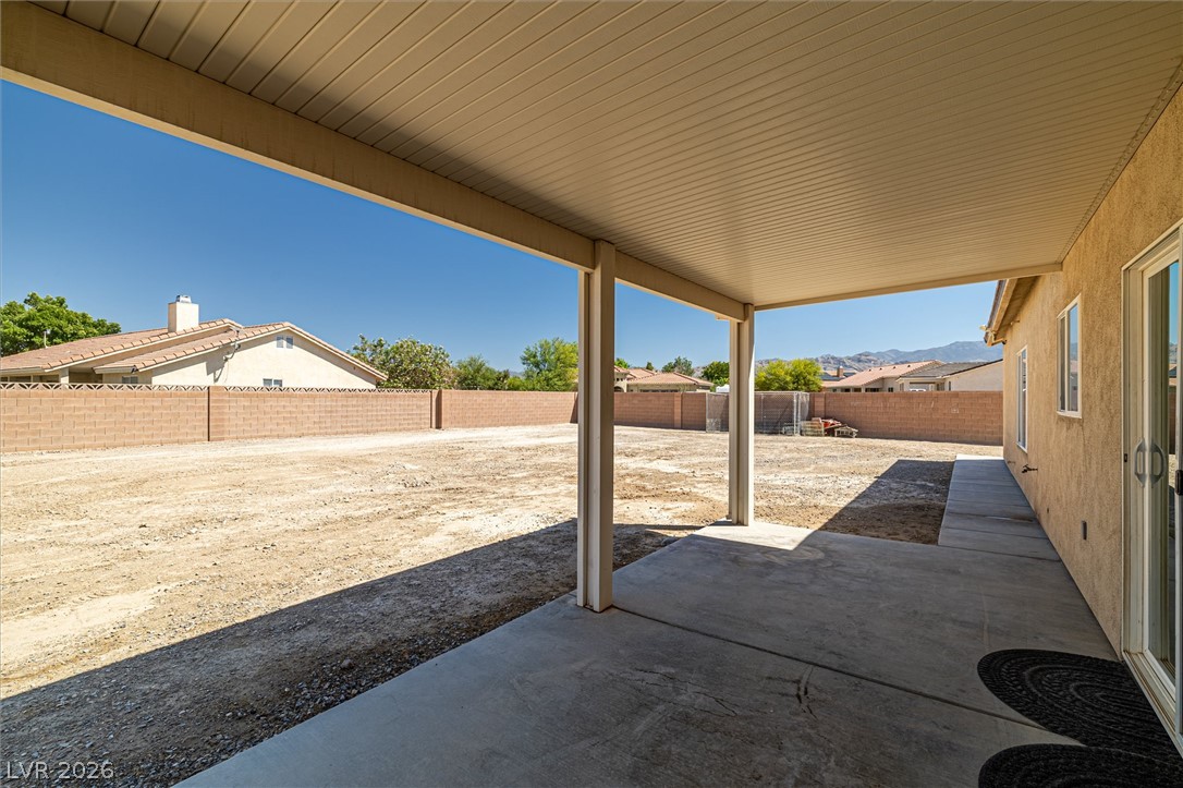 6720 Stubblefield Drive Pahrump, NV 89061 - Photo 33 of 51 A spacious covered patio overlooks a large, undeveloped private yard, perfect for future landscaping.