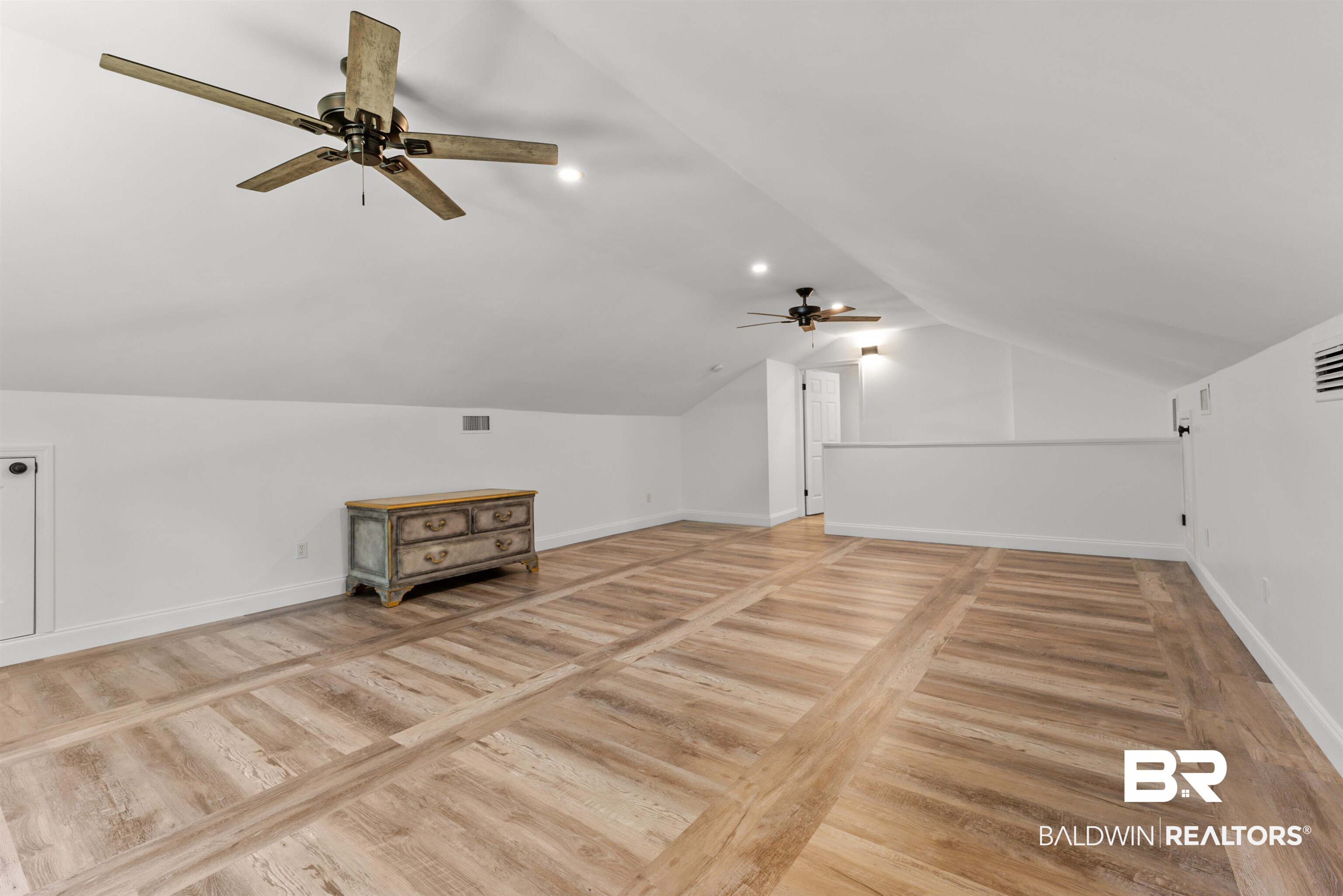 6447 Bemis Lane Bon Secour, AL 36511 - Photo 42 of 62 Spacious open loft area featuring wood-finish flooring with a plank pattern, two ceiling fans, and sloped ceilings