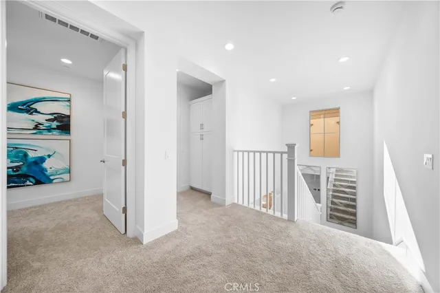 an empty room with windows and wardrobe