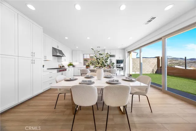 a view of a dining room with furniture window and wooden floor
