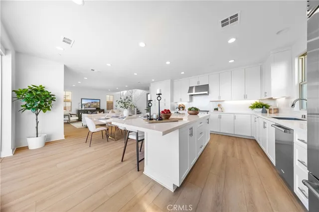 a kitchen with white cabinets sink and white appliances