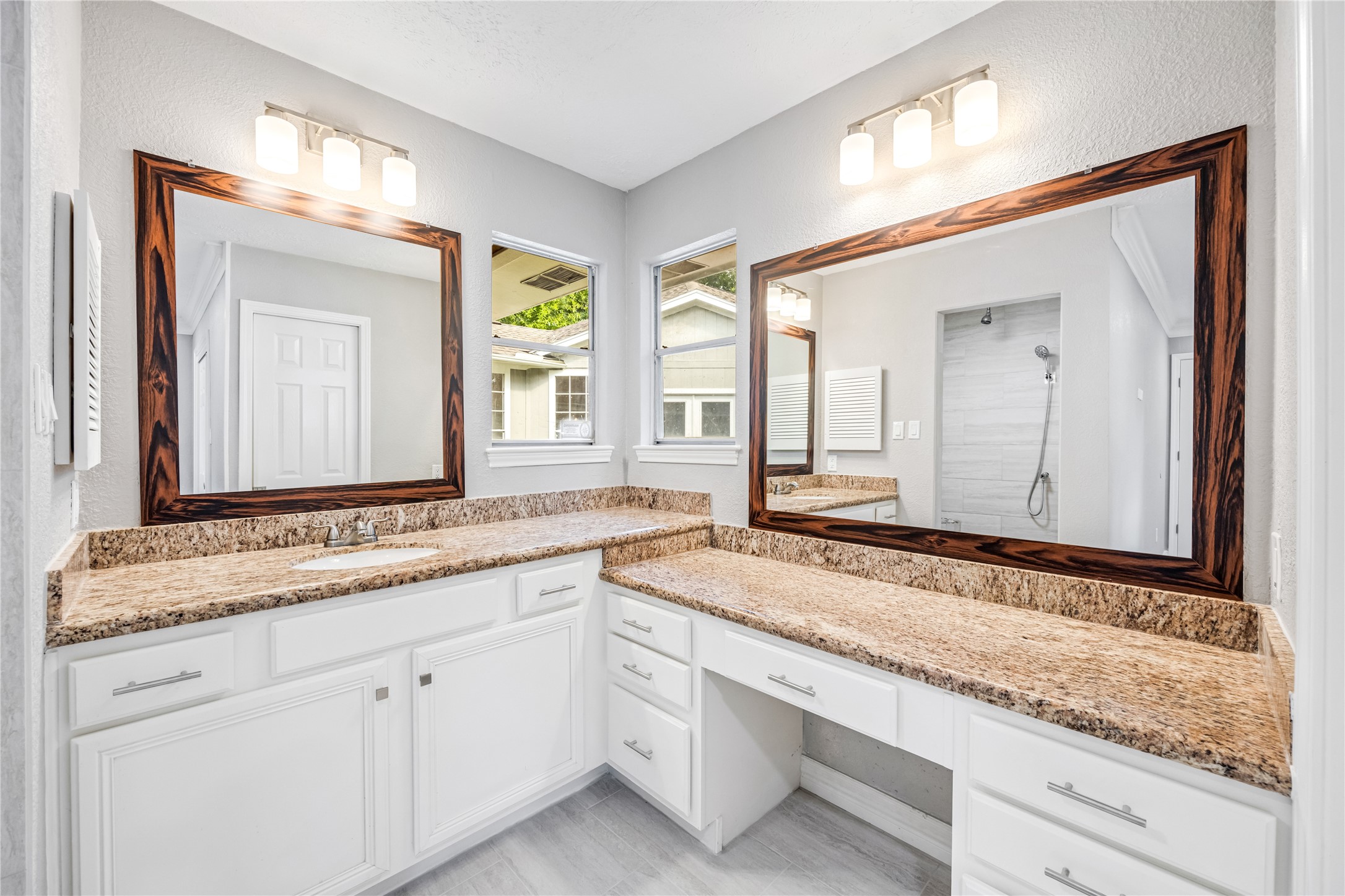 9806 Tanager Lane Conroe, TX 77385 - Photo 22 of 28 a bathroom with a granite countertop sink and a mirror