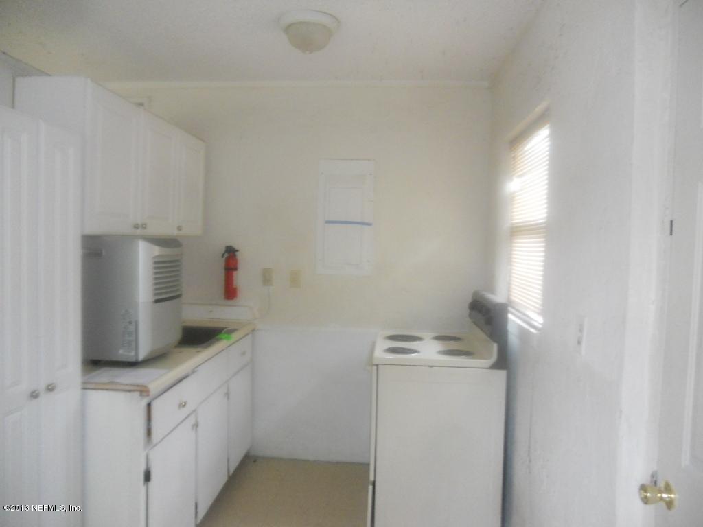 9702 Banks Road Jacksonville, FL 32246 - Photo 2 of 8 a room with a sink and cabinets