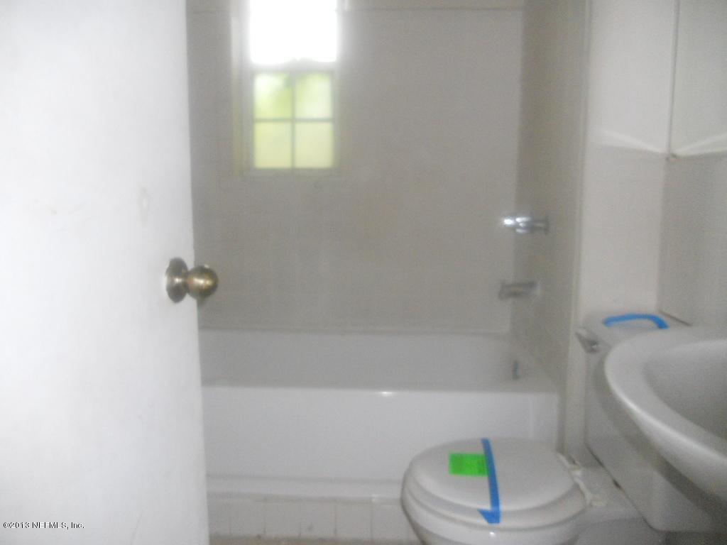 9702 Banks Road Jacksonville, FL 32246 - Photo 4 of 8 a bathroom with a bathtub and a shower