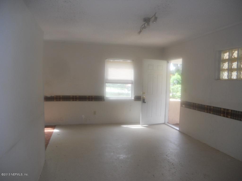 9702 Banks Road Jacksonville, FL 32246 - Photo 7 of 8 an empty room with windows