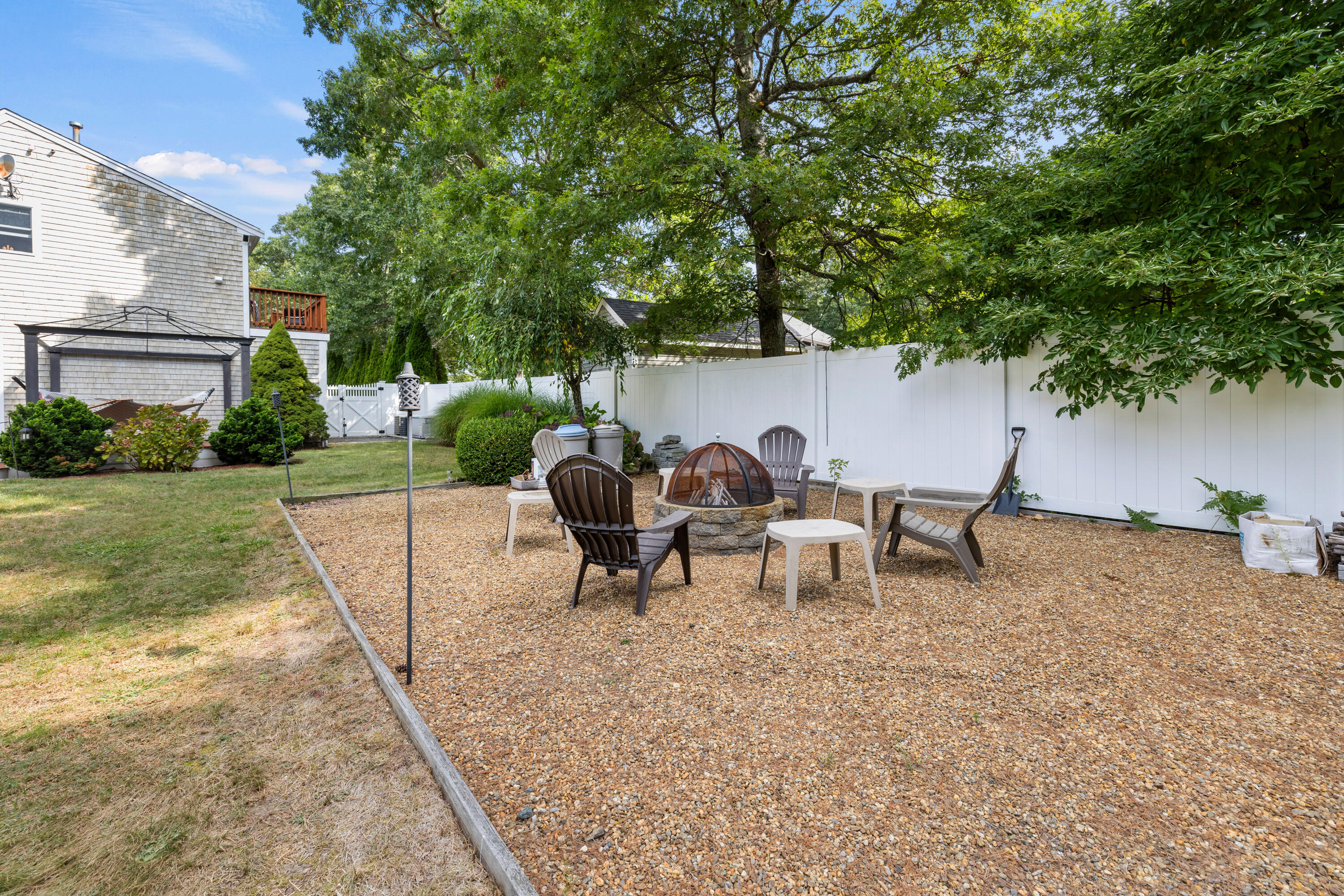 750 Old Barnstable Road Mashpee, MA 02649 - Photo 17 of 30 a view of a backyard with a table and chairs