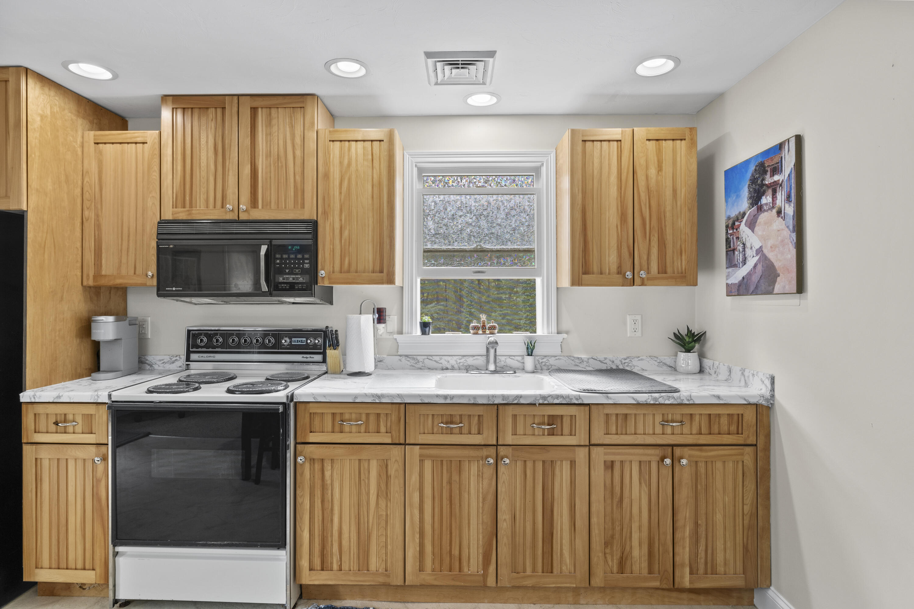 750 Old Barnstable Road Mashpee, MA 02649 - Photo 20 of 30 a kitchen with stainless steel appliances granite countertop a stove a sink and a microwave