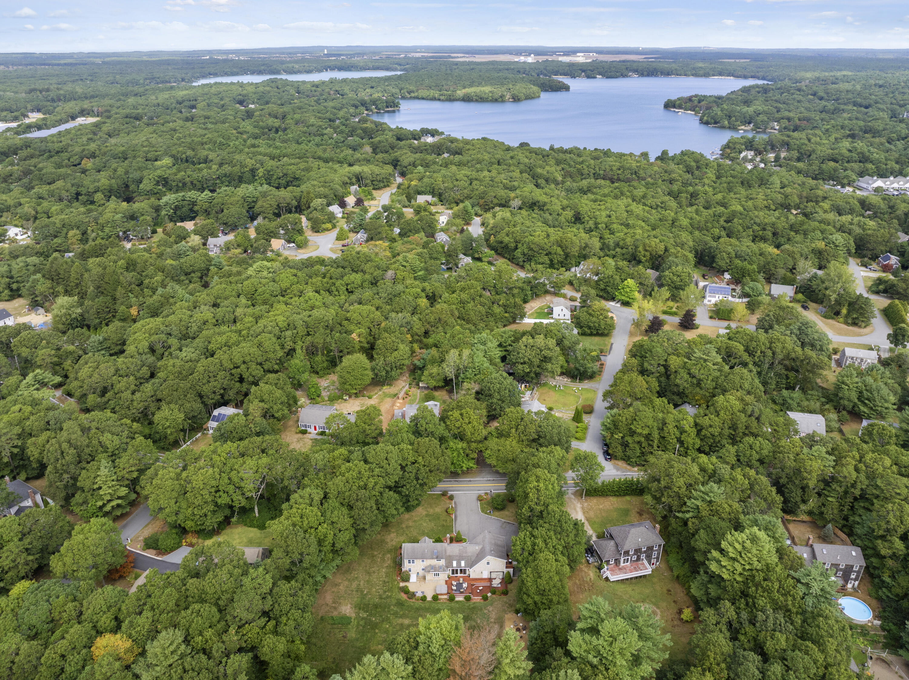 750 Old Barnstable Road Mashpee, MA 02649 - Photo 30 of 30 an aerial view of a houses with a lush green hillside