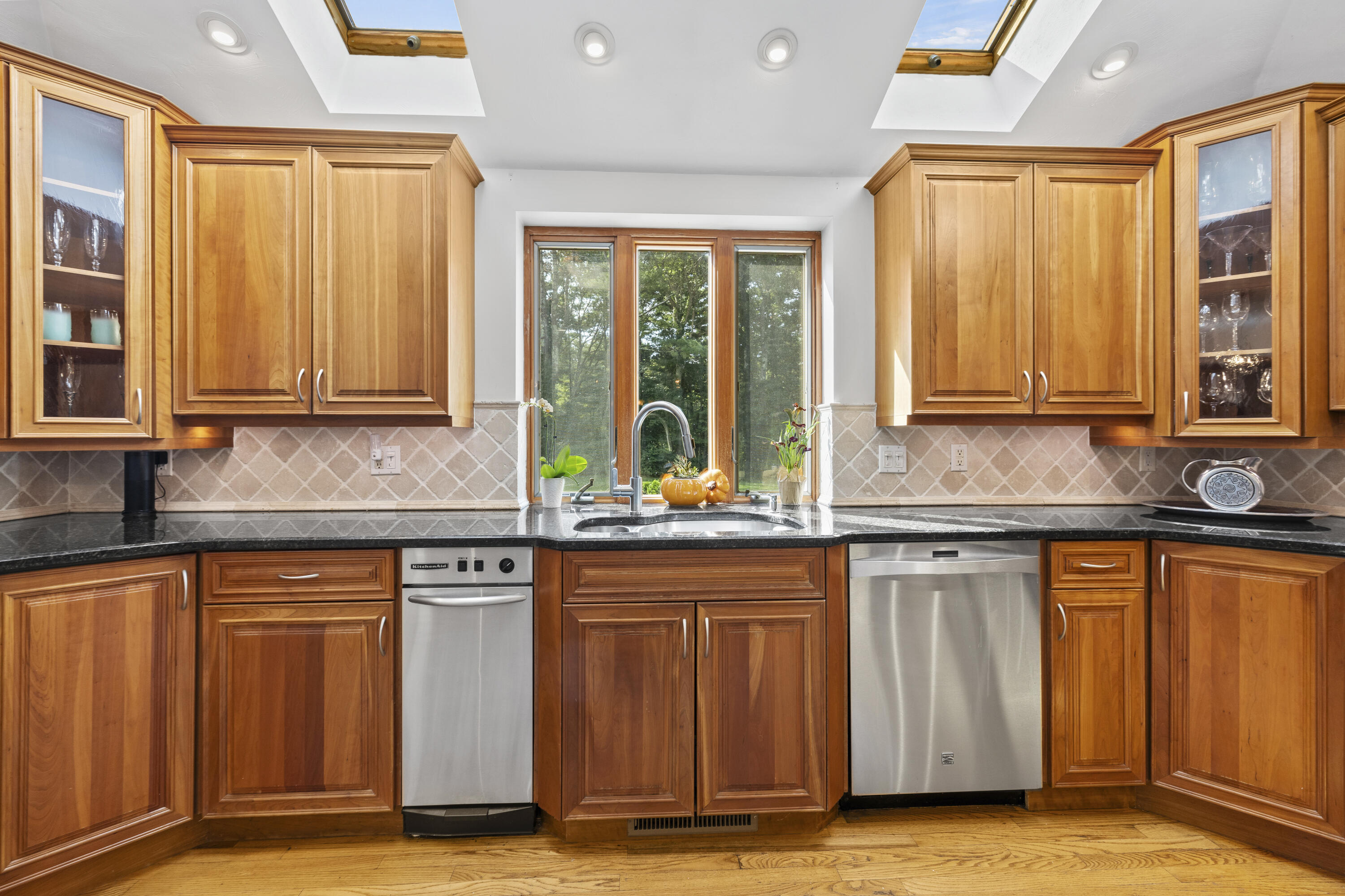 750 Old Barnstable Road Mashpee, MA 02649 - Photo 5 of 30 a kitchen with granite countertop wooden cabinets a sink and a window