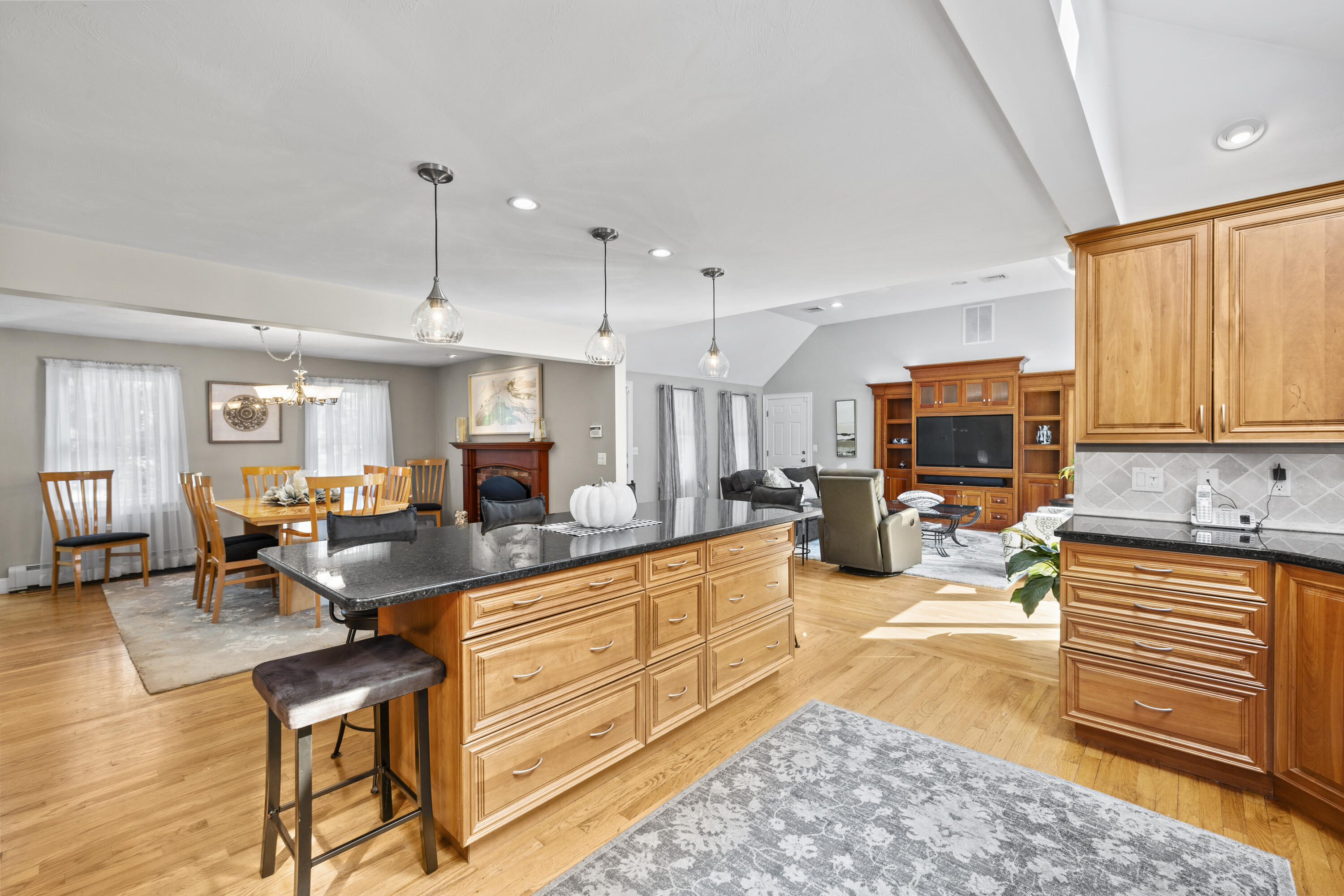 750 Old Barnstable Road Mashpee, MA 02649 - Photo 6 of 30 a living room with furniture a flat screen tv and kitchen view