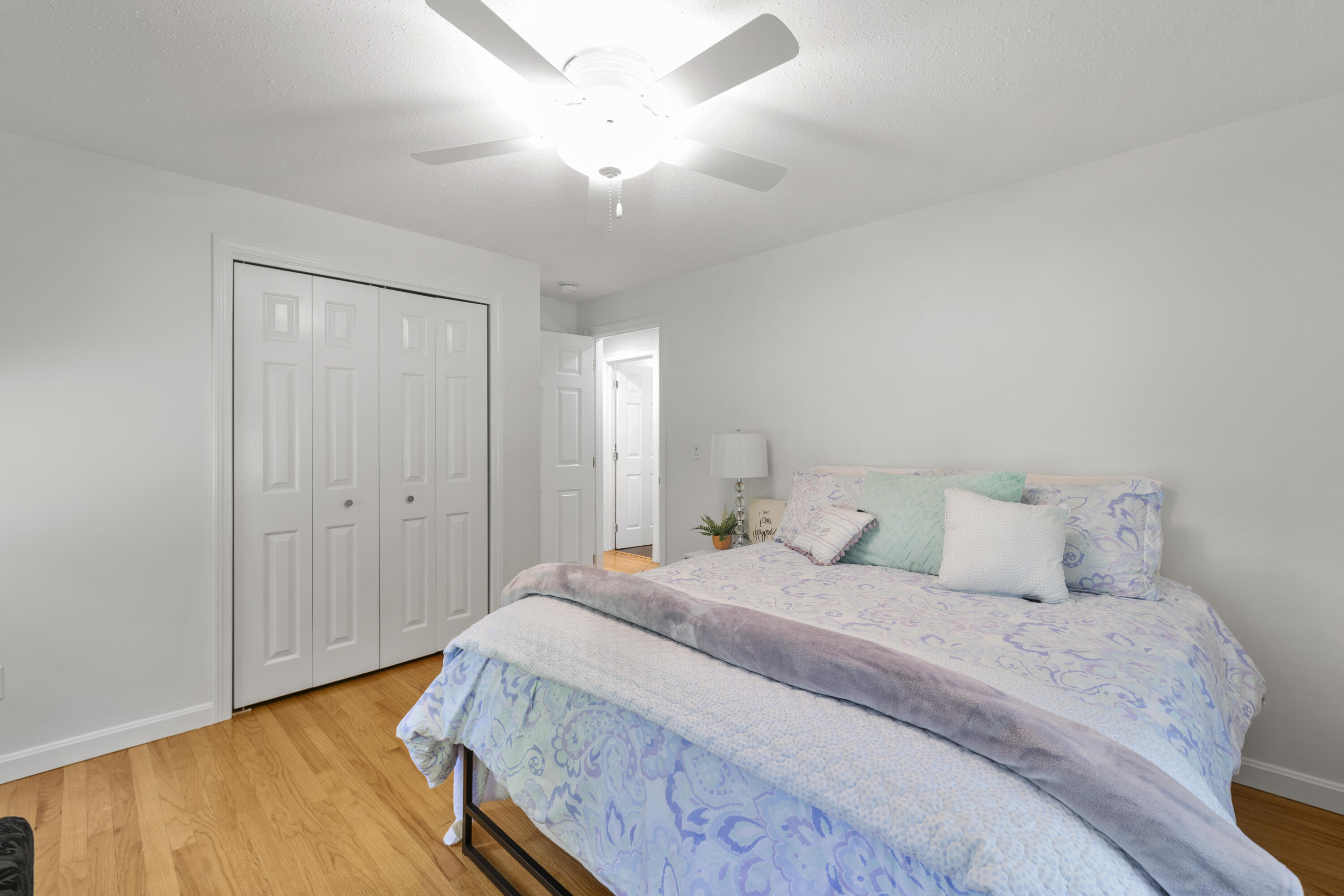 750 Old Barnstable Road Mashpee, MA 02649 - Photo 8 of 30 a bedroom with a bed and a chandelier