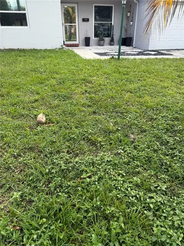 a swimming pool with outdoor seating and yard