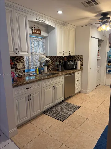 a kitchen with stainless steel appliances a sink stove and cabinets