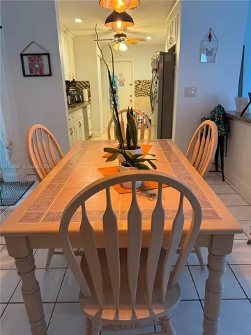 a dining room with furniture and a chandelier