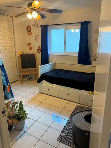 a room with gym equipment and a chandelier