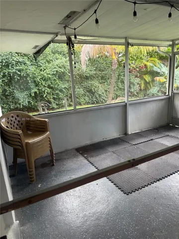 a living room with a couch and a window