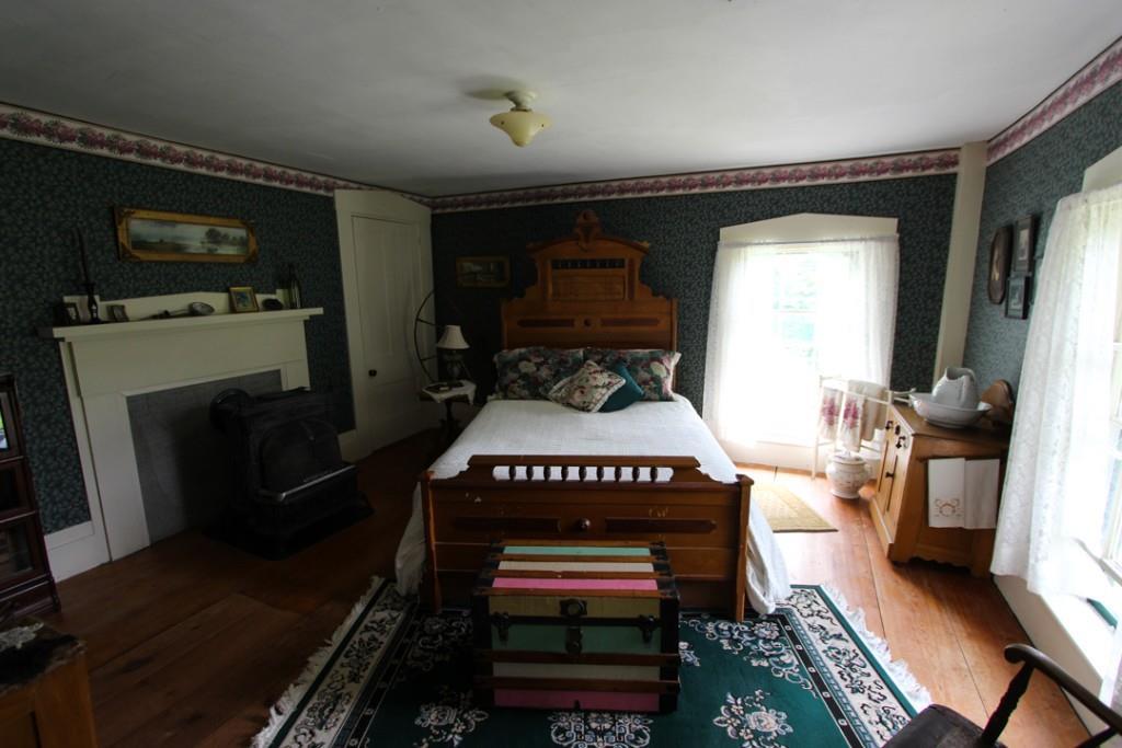 62 Roderick Road Newry, ME 04261 - Photo 29 of 35 Bedroom with wood stove, wood...