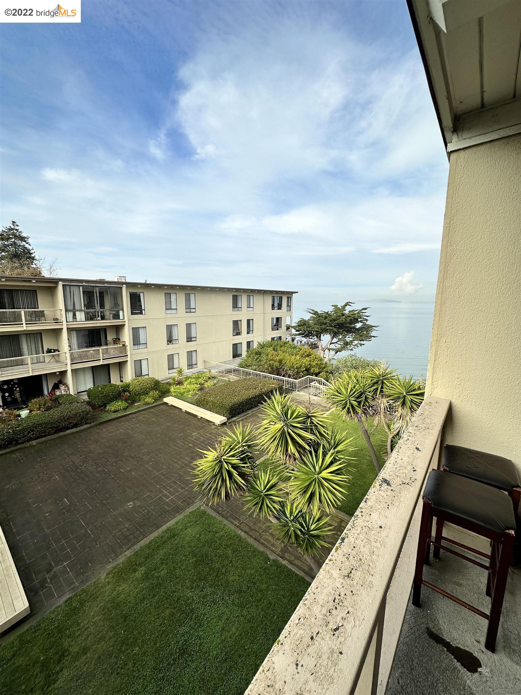 a view of swimming pool outdoor seating and city view