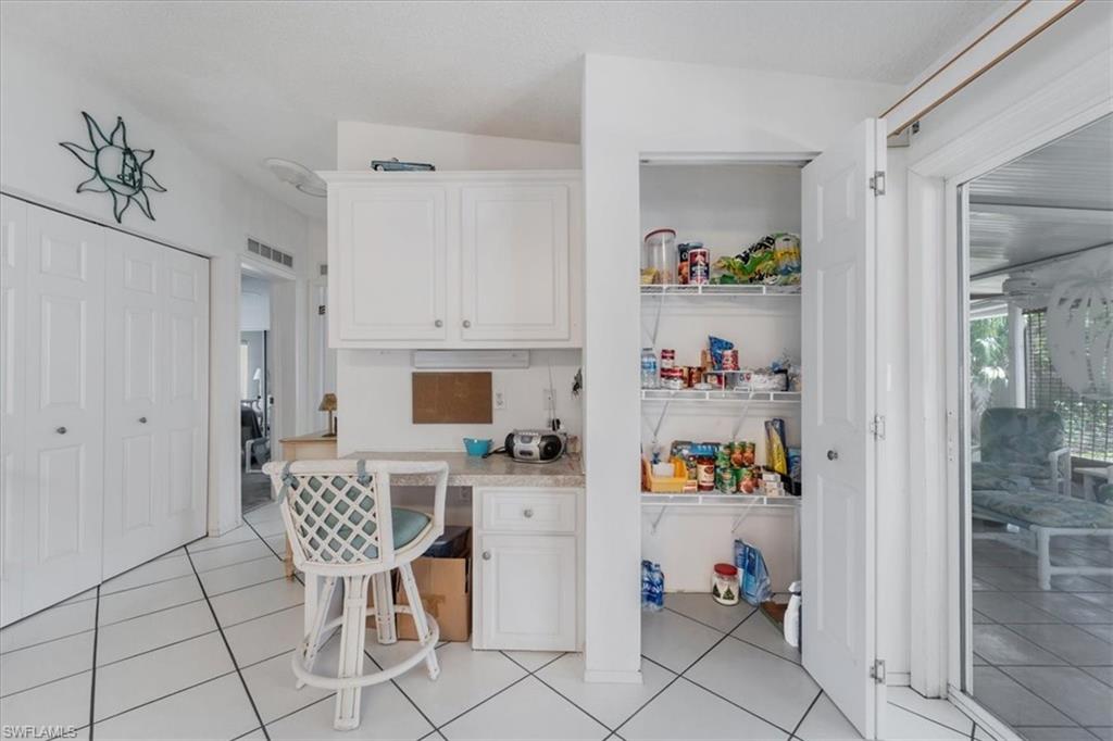 256 Riverwood Road Naples, FL 34114 - Photo 15 of 30 a workspace with furniture and a book shelf