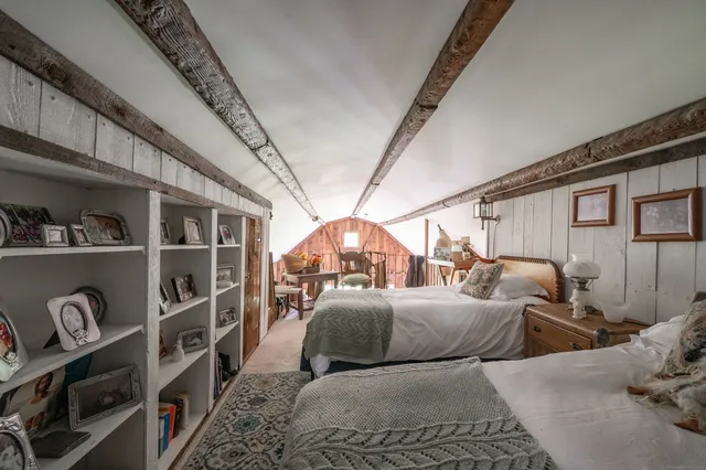 a bedroom with furniture and a chandelier