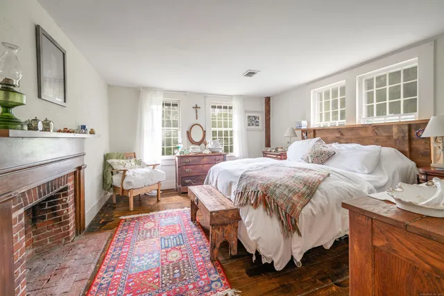 a bedroom with a bed and a fireplace