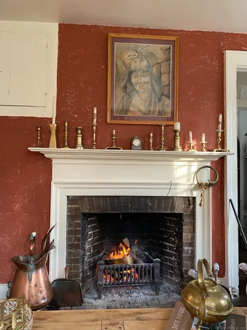 a fireplace with a vase on top of it