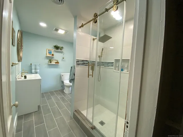 a bathroom with a glass shower door
