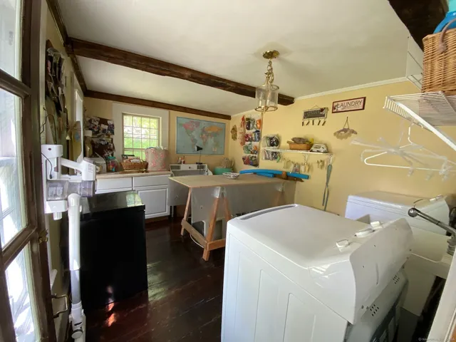 a kitchen with a sink a stove a refrigerator and wooden floor