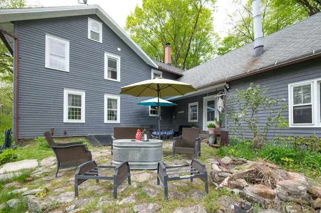 a view of patio with a table and chairs under an umbrella