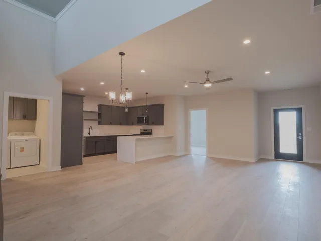 a view of a kitchen with a sink and a living room