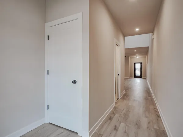 a view of hallway with wooden floor
