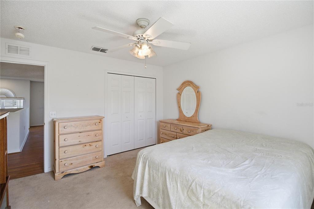 206 Taranto Way Kissimmee, FL 34758 - Photo 28 of 45 a bedroom with a bed and a chandelier