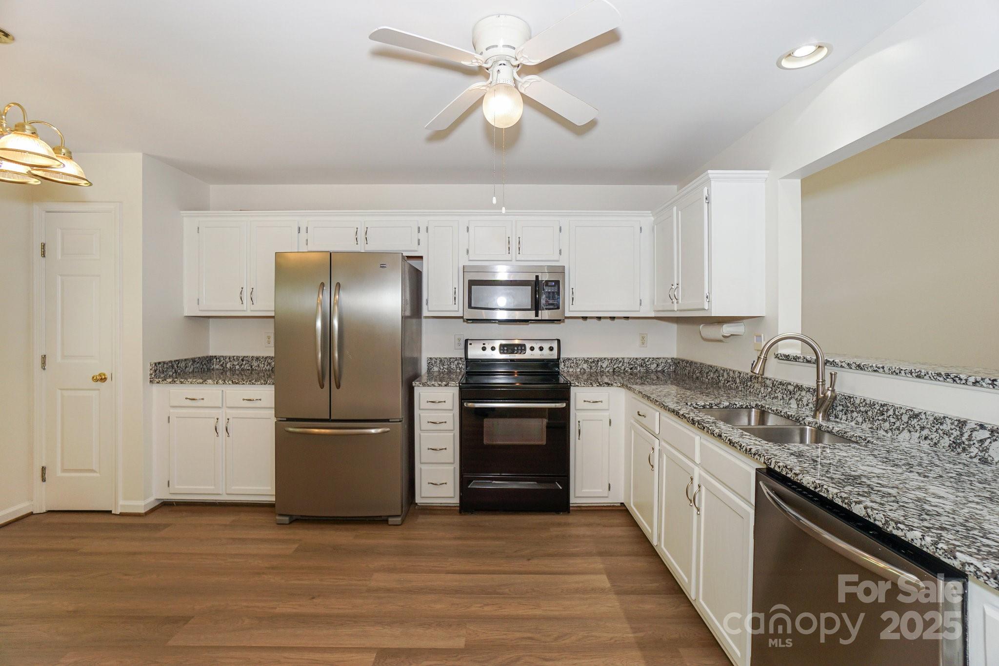 2485 Acadia Court Kannapolis, NC 28083 - Photo 13 of 34 a kitchen with stainless steel appliances granite countertop a sink and a refrigerator
