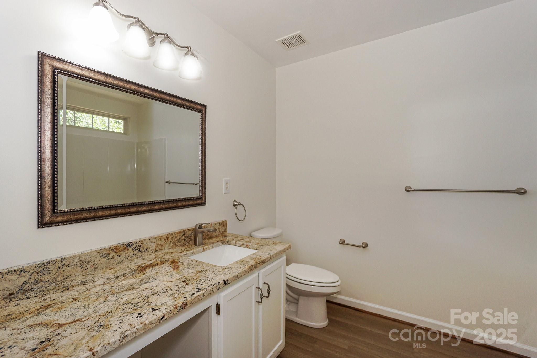 2485 Acadia Court Kannapolis, NC 28083 - Photo 17 of 34 a bathroom with a granite countertop sink and a mirror