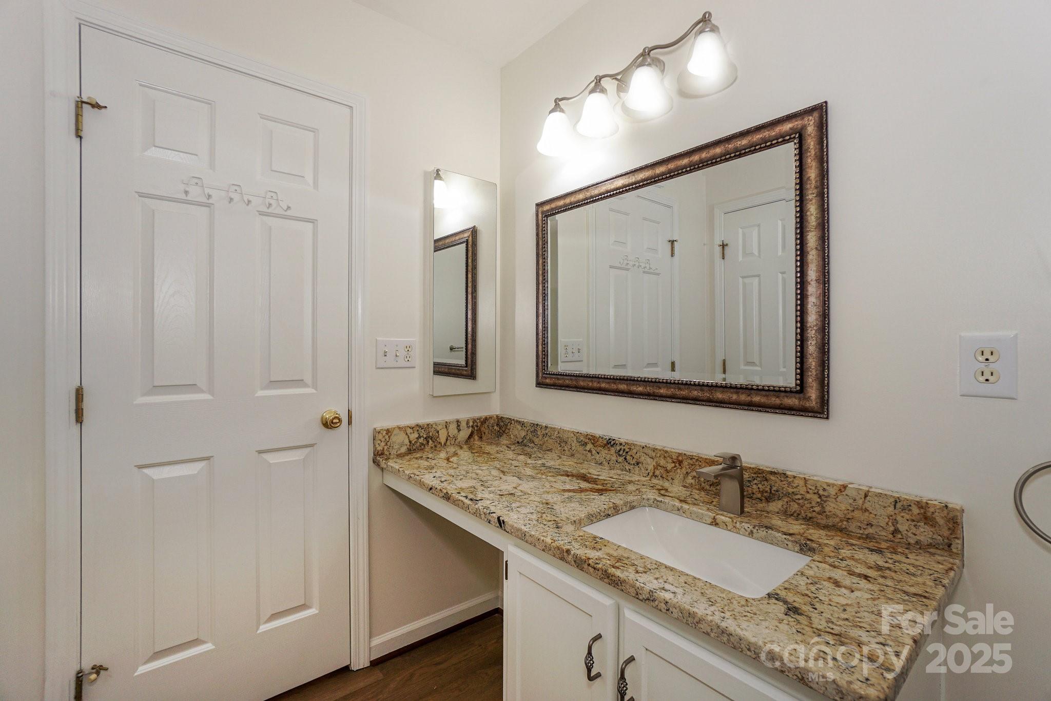 2485 Acadia Court Kannapolis, NC 28083 - Photo 19 of 34 a bathroom with a granite countertop sink and a mirror