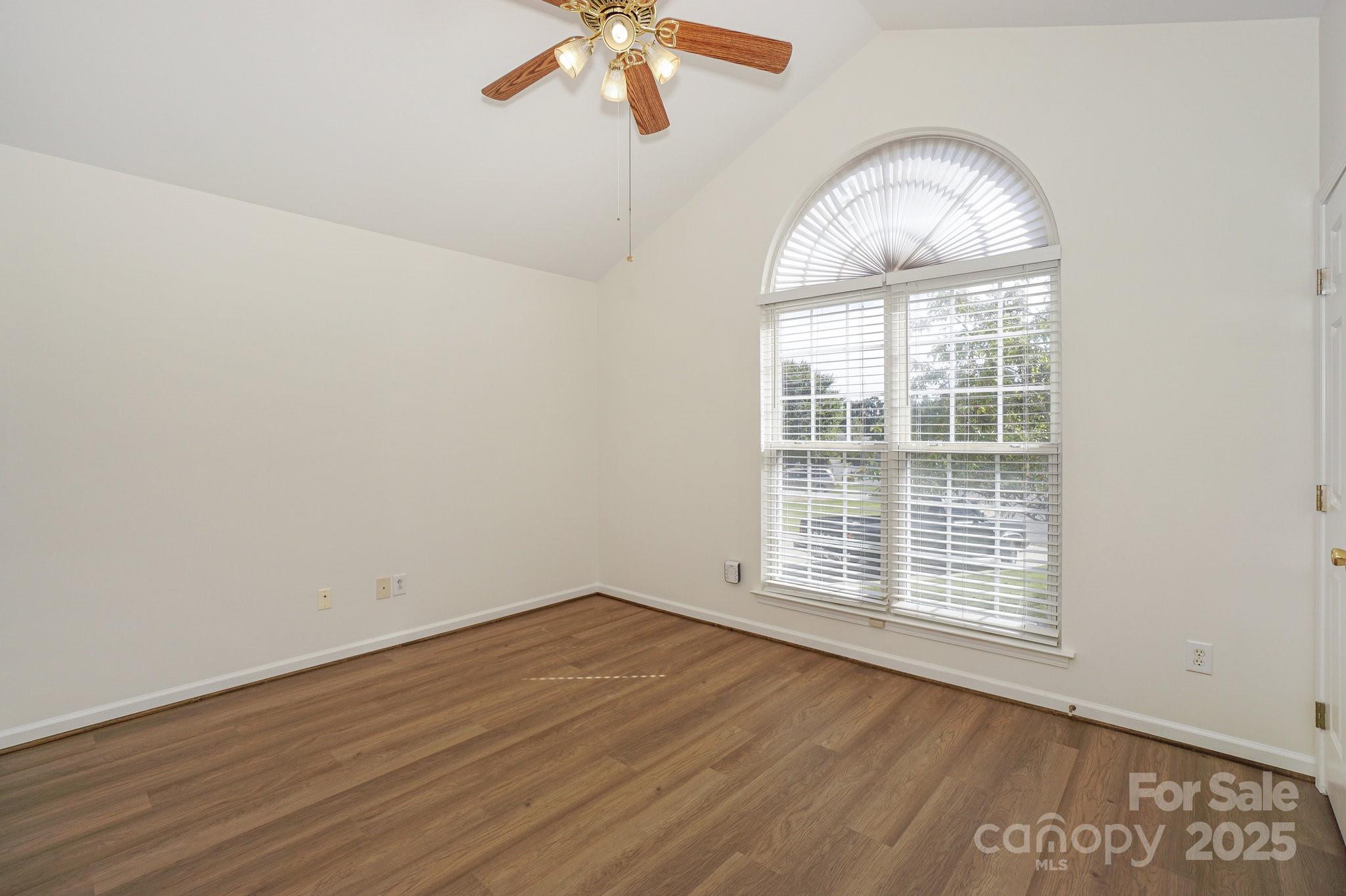 2485 Acadia Court Kannapolis, NC 28083 - Photo 21 of 34 an empty room with wooden floor fan and windows