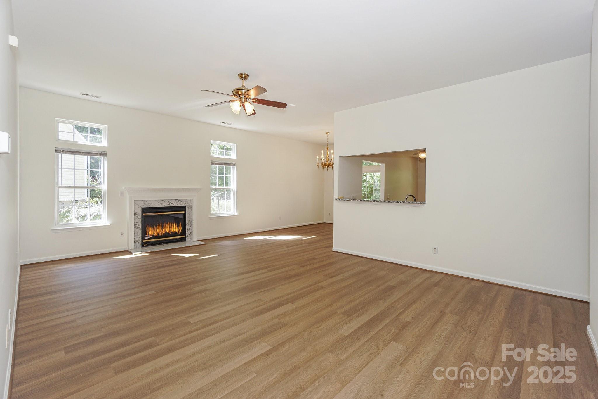2485 Acadia Court Kannapolis, NC 28083 - Photo 5 of 34 a view of an empty room with window and wooden floor