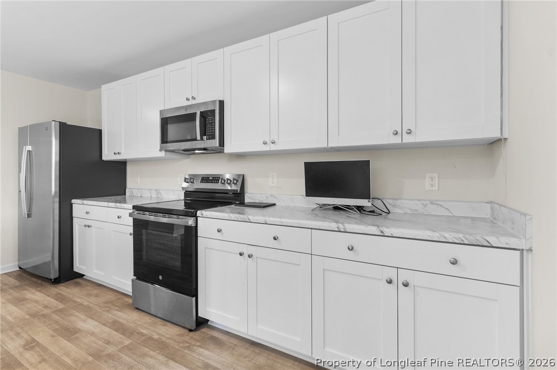 33 Pointer Way Parkton, NC 28371 - Photo 15 of 44 a kitchen with stainless steel appliances granite countertop white cabinets and a refrigerator