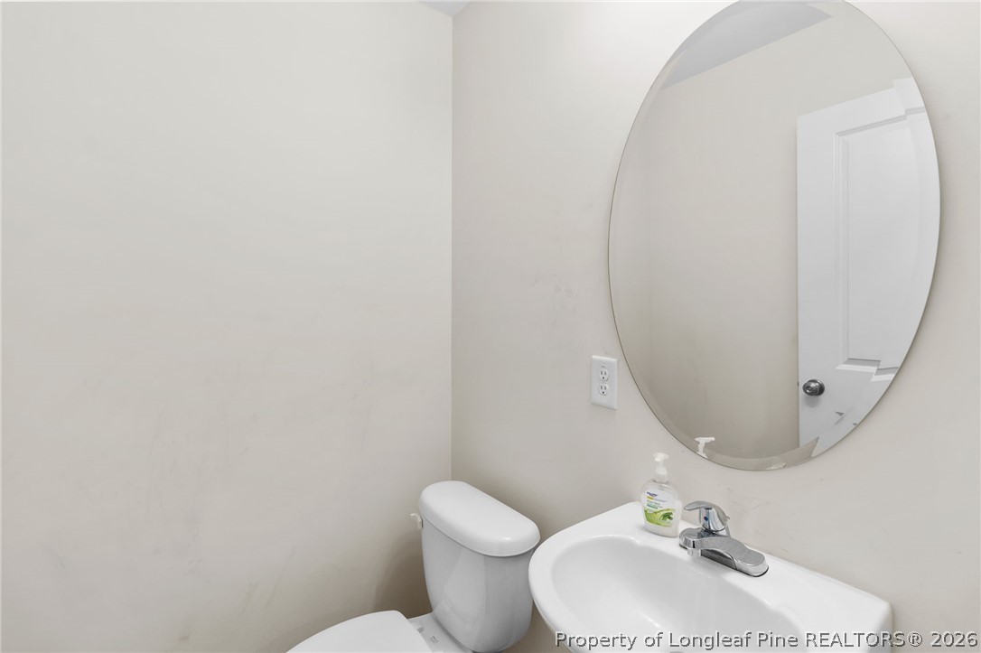 33 Pointer Way Parkton, NC 28371 - Photo 18 of 44 a bathroom with a toilet sink and mirror