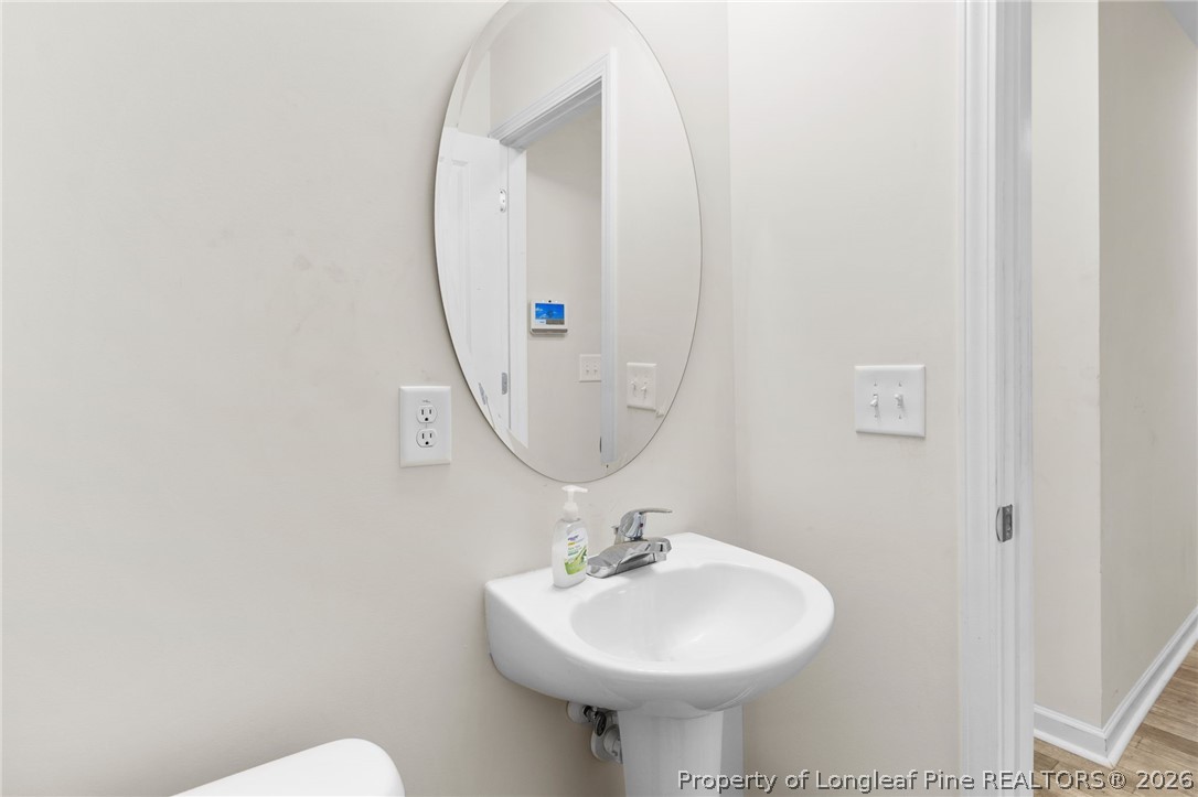 33 Pointer Way Parkton, NC 28371 - Photo 19 of 44 a bathroom with a sink a mirror and a toilet