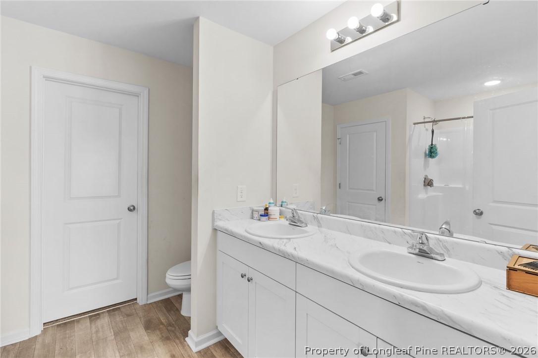 33 Pointer Way Parkton, NC 28371 - Photo 23 of 44 a bathroom with a double vanity sink mirror and toilet