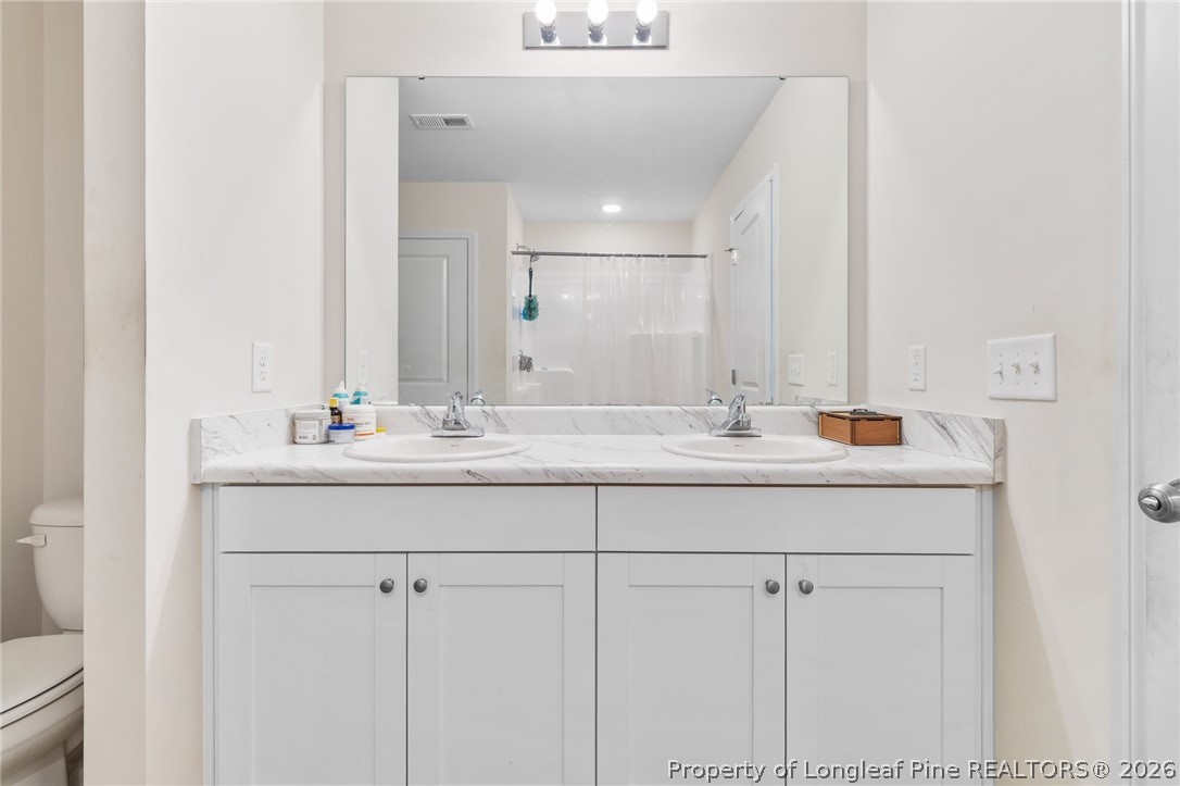 33 Pointer Way Parkton, NC 28371 - Photo 24 of 44 a bathroom with sinks mirror and vanity