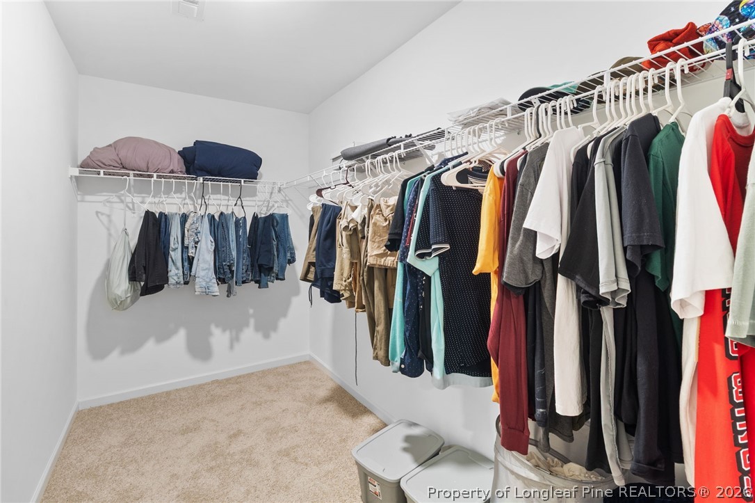 33 Pointer Way Parkton, NC 28371 - Photo 25 of 44 a view of walk in closet with clothes and shoes