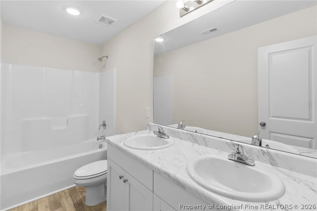 33 Pointer Way Parkton, NC 28371 - Photo 29 of 44 a bathroom with a sink and a mirror