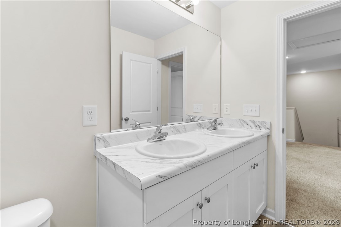 33 Pointer Way Parkton, NC 28371 - Photo 30 of 44 a bathroom with a granite countertop sink and a mirror