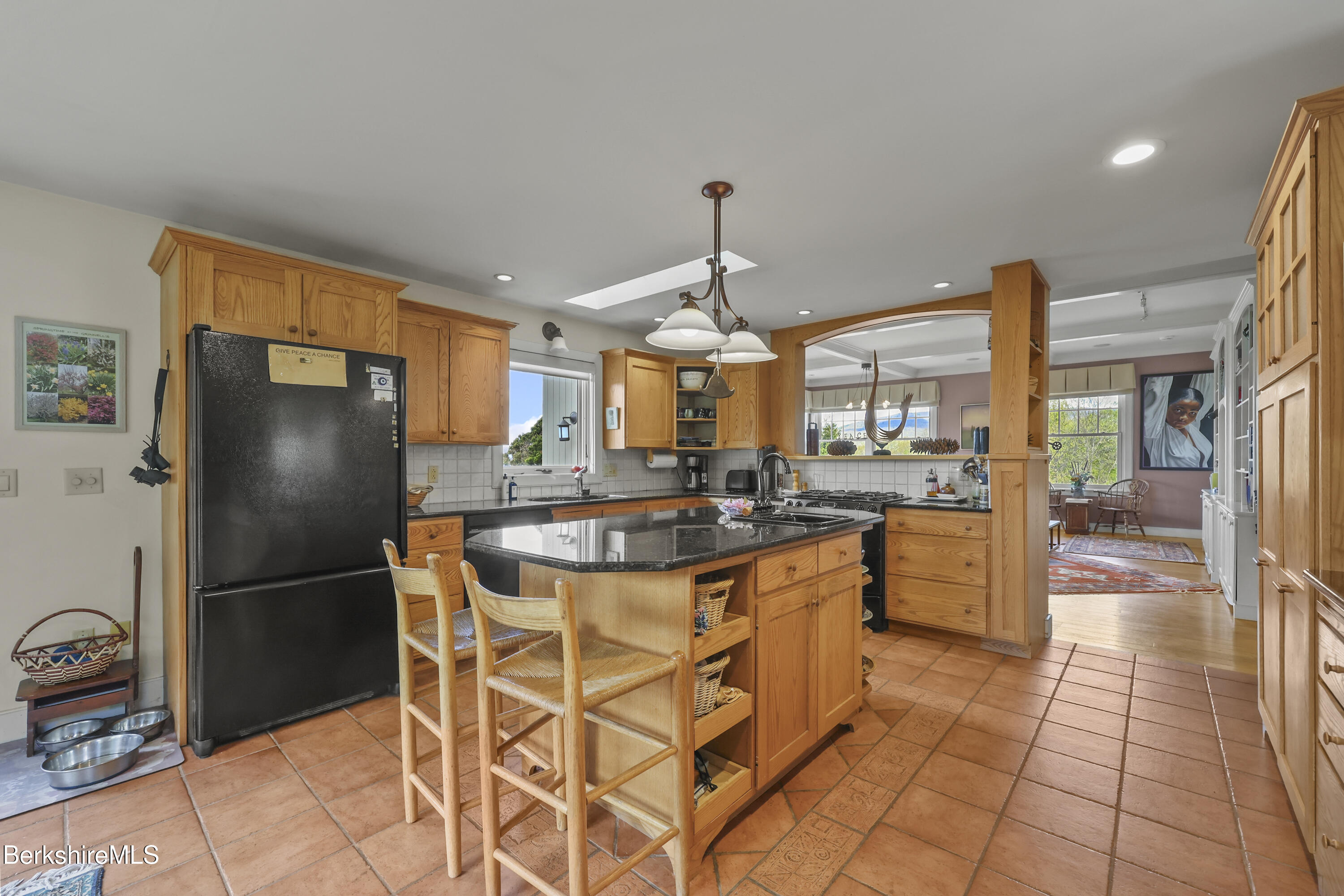 821 Pattison Road North Adams, MA 01247 - Photo 21 of 68 a kitchen with stainless steel appliances granite countertop a refrigerator a sink a stove a dining table and chairs