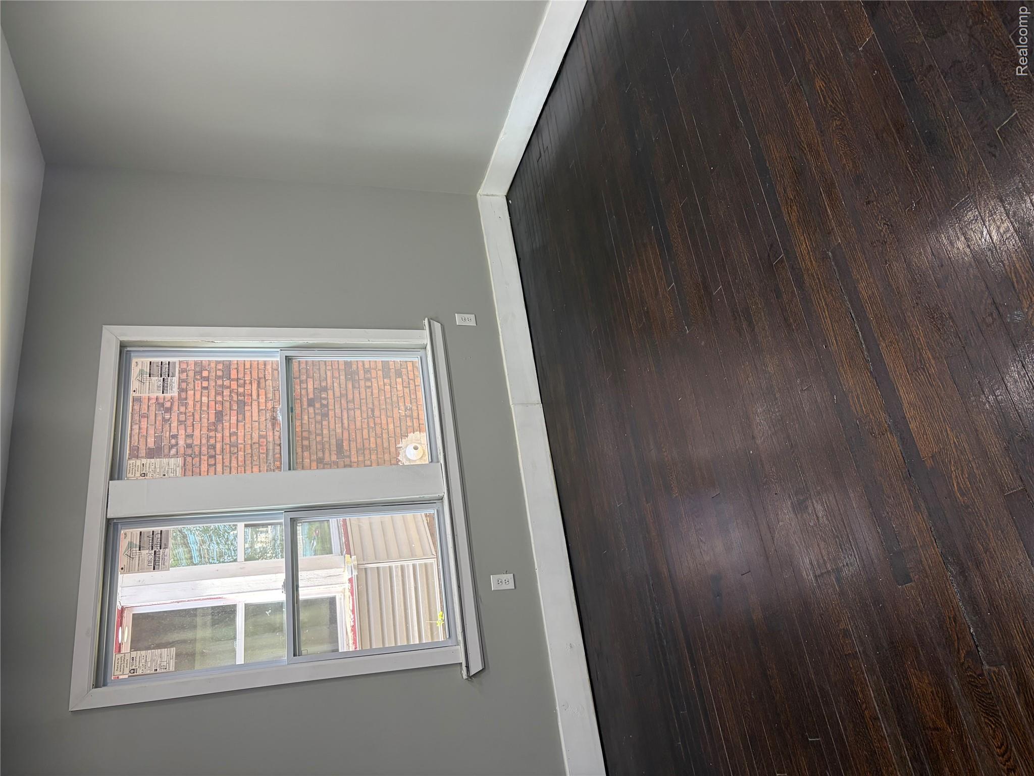2420 Field Street Detroit, MI 48214 - Photo 5 of 15 Empty room with baseboards and dark wood-style floors