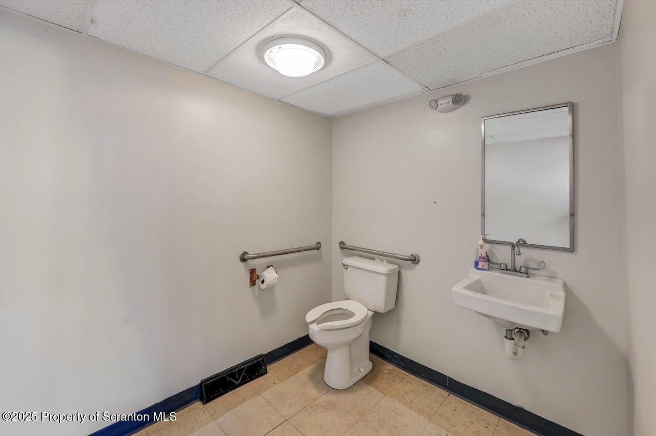 535 Green Ridge Street Scranton, PA 18509 - Photo 18 of 72 a white toilet sitting next to a bathroom sink