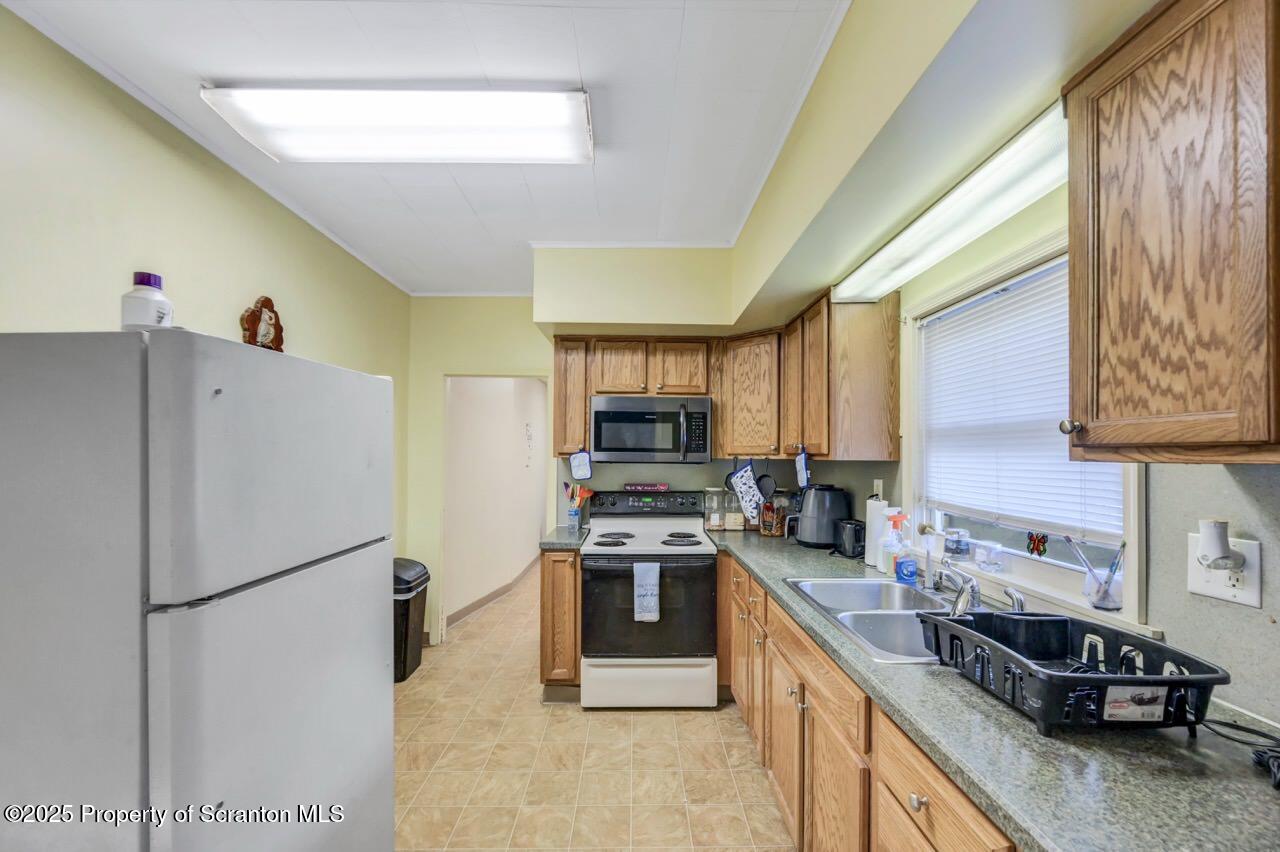 535 Green Ridge Street Scranton, PA 18509 - Photo 35 of 72 a kitchen with stainless steel appliances granite countertop a refrigerator a stove a sink dishwasher and a refrigerator